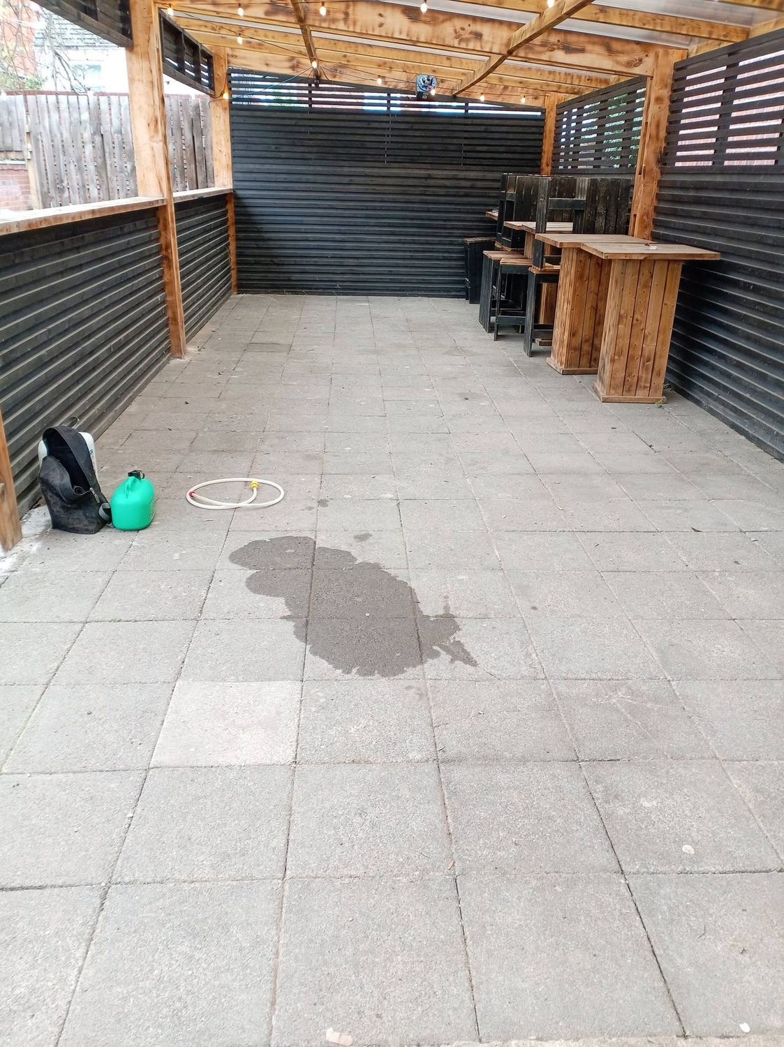 Bright, restored clean patio slabs after pressure washing